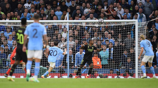 Manchester City's Portuguese midfielder Bernardo Silva (C) scores the team's second goal during the UEFA Champions League second leg semi-final football match between Manchester City and Real Madrid at the Etihad Stadium in Manchester, north west England, on May 17, 2023. (Photo by Oli SCARFF / AFP) 