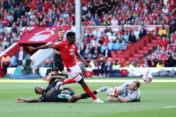 NOTTINGHAM, ENGLAND - MAY 20: Taiwo Awoniyi of Nottingham Forest scores the team's first goal past Aaron Ramsdale of Arsenal during the Premier League match between Nottingham Forest and Arsenal FC at City Ground on May 20, 2023 in Nottingham, England. 