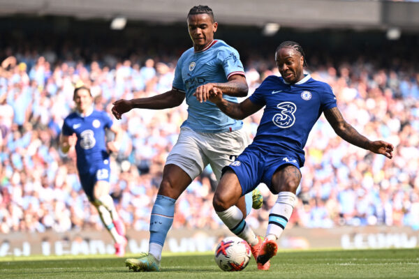 Chelsea's English midfielder Raheem Sterling (R) shoots past Manchester City's Swiss defender Manuel Akanji but fails to score during the English Premier League football match between Manchester City and Chelsea at the Etihad Stadium in Manchester, north west England, on May 21, 2023. (Photo by Oli SCARFF / AFP) / RESTRICTED TO EDITORIAL USE. No use with unauthorized audio, video, data, fixture lists, club/league logos or 'live' services. Online in-match use limited to 120 images. An additional 40 images may be used in extra time. No video emulation. Social media in-match use limited to 120 images. An additional 40 images may be used in extra time. No use in betting publications, games or single club/league/player publications. / 
