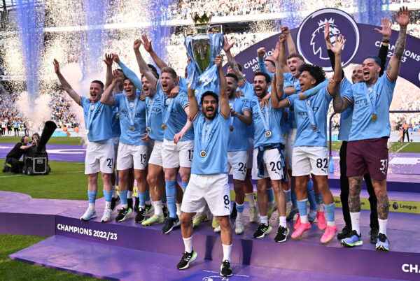 Manchester City's German midfielder Ilkay Gundogan lifts the trophy as Manchester City players celebrate winning the title at the presentation ceremony following the English Premier League football match between Manchester City and Chelsea at the Etihad Stadium in Manchester, north west England, on May 21, 2023. Manchester City won the Premier League for the fifth time in six seasons on Saturday, taking a first step to a possible golden treble of trophies as second-placed Arsenal lost 1-0 at Nottingham Forest. (Photo by Oli SCARFF / AFP) / RESTRICTED TO EDITORIAL USE. No use with unauthorized audio, video, data, fixture lists, club/league logos or 'live' services. Online in-match use limited to 120 images. An additional 40 images may be used in extra time. No video emulation. Social media in-match use limited to 120 images. An additional 40 images may be used in extra time. No use in betting publications, games or single club/league/player publications. / 