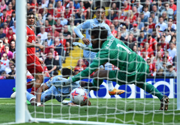 Aston Villa's English midfielder Jacob Ramsey (R) scores the opening goal past Liverpool's Brazilian goalkeeper Alisson Becker during the English Premier League football match between Liverpool and Aston Villa at Anfield in Liverpool, north west England on May 20, 2023. (Photo by PETER POWELL / AFP) / RESTRICTED TO EDITORIAL USE. No use with unauthorized audio, video, data, fixture lists, club/league logos or 'live' services. Online in-match use limited to 120 images. An additional 40 images may be used in extra time. No video emulation. Social media in-match use limited to 120 images. An additional 40 images may be used in extra time. No use in betting publications, games or single club/league/player publications. / 