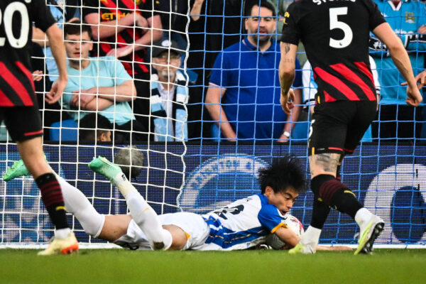 Brighton's Japanese midfielder Kaoru Mitoma (down C) scores a goal that will be disallowed during the English Premier League football match between Brighton and Hove Albion and Manchester City at the American Express Community Stadium in Brighton, southern England on May 24, 2023. (Photo by Glyn KIRK / AFP) / RESTRICTED TO EDITORIAL USE. No use with unauthorized audio, video, data, fixture lists, club/league logos or 'live' services. Online in-match use limited to 120 images. An additional 40 images may be used in extra time. No video emulation. Social media in-match use limited to 120 images. An additional 40 images may be used in extra time. No use in betting publications, games or single club/league/player publications. / 