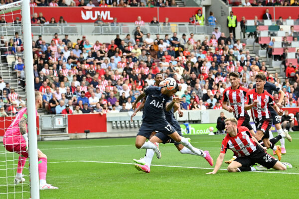 TOPSHOT - Tottenham Hotspur's Argentinian defender #17 Cristian Romero (C) heads home the opening goal of the English Premier League football match between Brentford and Tottenham Hotspur at Gtech Community Stadium in London on August 13, 2023. (Photo by JUSTIN TALLIS / AFP) / RESTRICTED TO EDITORIAL USE. No use with unauthorized audio, video, data, fixture lists, club/league logos or 'live' services. Online in-match use limited to 120 images. An additional 40 images may be used in extra time. No video emulation. Social media in-match use limited to 120 images. An additional 40 images may be used in extra time. No use in betting publications, games or single club/league/player publications. / 