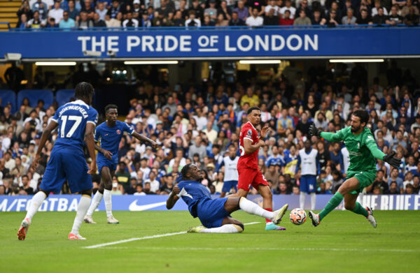 LONDON, ENGLAND - AUGUST 13: Axel Disasi of Chelsea scores the team's first goal past Alisson Becker of Liverpool during the Premier League match between Chelsea FC and Liverpool FC at Stamford Bridge on August 13, 2023 in London, England. 