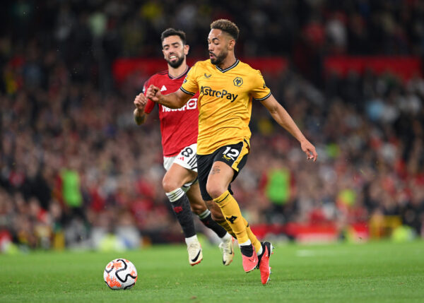 MANCHESTER, ENGLAND - AUGUST 14: Wolves player Matheus Cunha outpaces Manchester United player Bruno Fernandes during the Premier League match between Manchester United and Wolverhampton Wanderers at Old Trafford on August 14, 2023 in Manchester, England. 