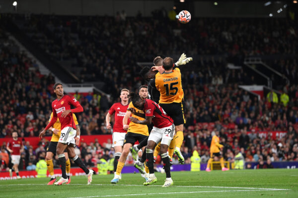 MANCHESTER, ENGLAND - AUGUST 14: Manchester United goalkeeper Andre Onana challenges Wolves defender Craig Dawson which goes to VAR for a penalty check during the Premier League match between Manchester United and Wolverhampton Wanderers at Old Trafford on August 14, 2023 in Manchester, England. 