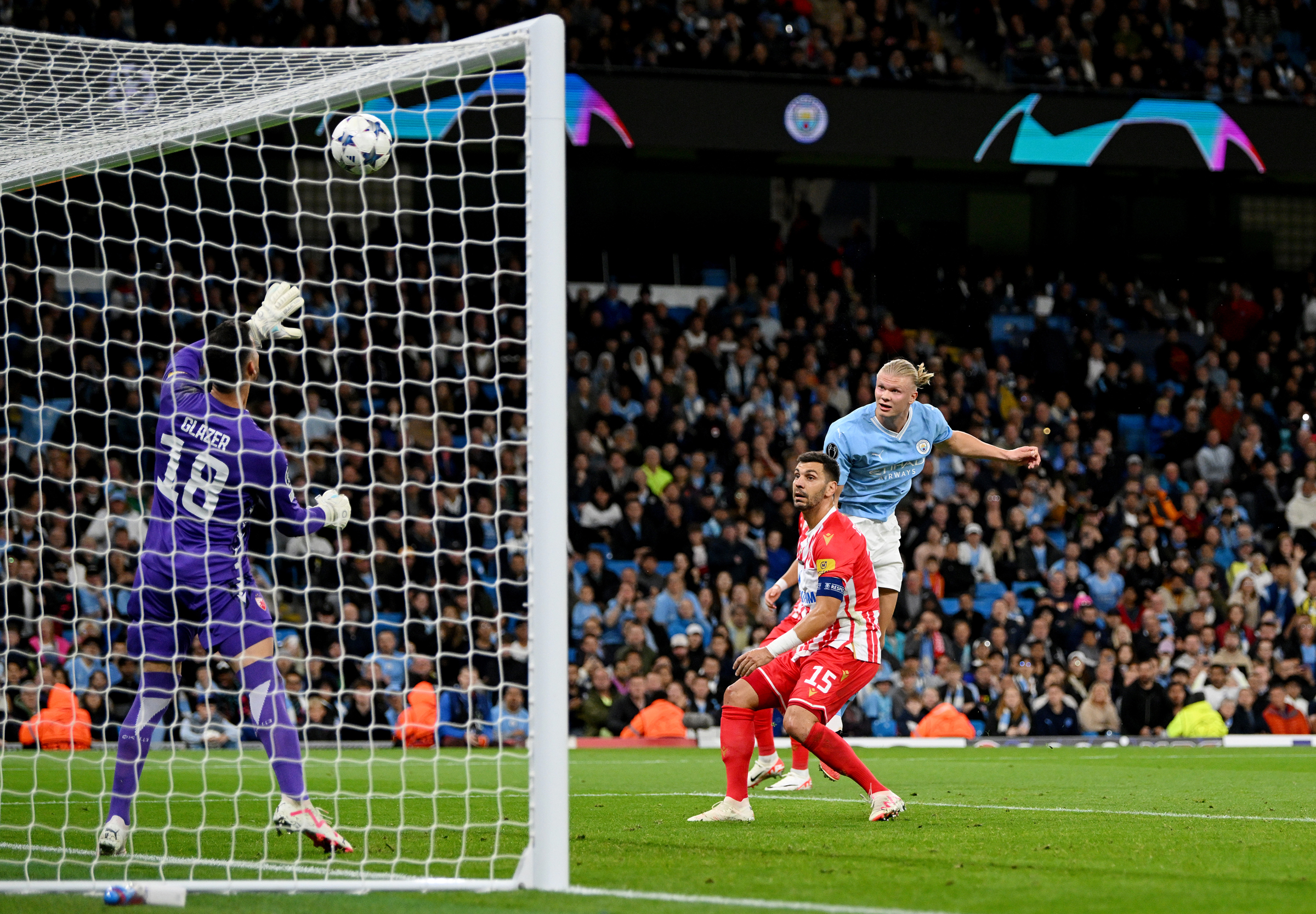 MANCHESTER, ENGLAND - SEPTEMBER 19: Erling Haaland of Manchester City heads the ball and hits the crossbar during the UEFA Champions League Group G match between Manchester City and FK Crvena zvezda at Etihad Stadium on September 19, 2023 in Manchester, England. 