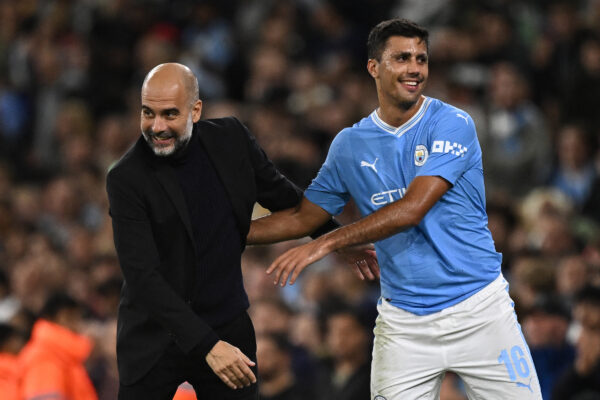 Manchester City's Spanish manager Pep Guardiola congratulates Manchester City's Spanish midfielder #16 Rodri as he leaves the pitch during the UEFA Champions League Group G football match between Manchester City and FC Crvena Zvezda (Red Star Belgrade) at the Etihad Stadium in Manchester, north west England, on September 19, 2023. (Photo by Oli SCARFF / AFP) 
