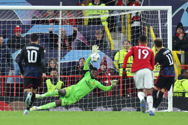 MANCHESTER, ENGLAND - OCTOBER 24: Andre Onana of Manchester United saves a penalty by Jordan Larsson of FC Copenhagen during the UEFA Champions League match between Manchester United and F.C. Copenhagen at Old Trafford on October 24, 2023 in Manchester, England. 