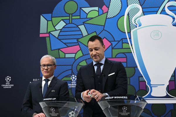 UEFA Champions League ambassador and British former football player, John Terry (R) opens a draw ball alongside UEFA Deputy General Secretary, Giorgio Marchetti during the 2023-2024 UEFA Champions League football tournament round of 16 draw at the House of European Football in Nyon, on December 18, 2023. (Photo by Fabrice COFFRINI / AFP) 