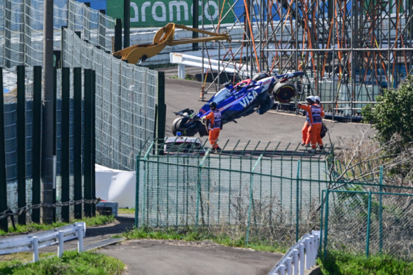 Officials remove the car of RB's Australian driver Daniel Ricciardo from the track after he crashed out at the start of the Formula One Japanese Grand Prix race at the Suzuka circuit in Suzuka, Mie prefecture on April 7, 2024. (Photo by Yuichi YAMAZAKI / AFP) (Photo by YUICHI YAMAZAKI/AFP via Getty Images)