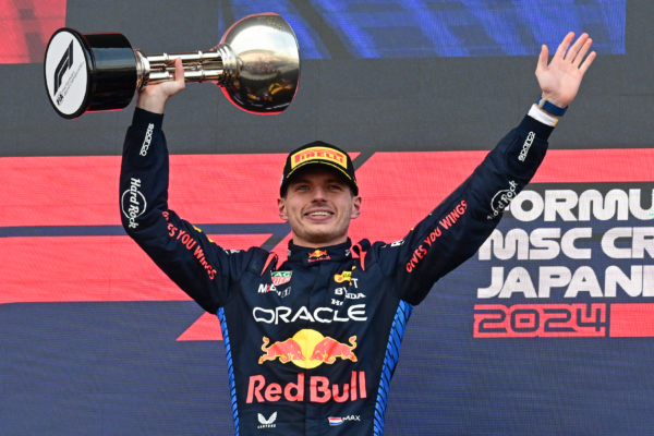 TOPSHOT - Red Bull Racing's Dutch driver Max Verstappen celebrates on the podium after the end of the Formula One Japanese Grand Prix race at the Suzuka circuit in Suzuka, Mie prefecture on April 7, 2024. (Photo by Yuichi YAMAZAKI / AFP) (Photo by YUICHI YAMAZAKI/AFP via Getty Images)