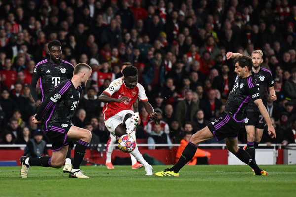 LONDON, ENGLAND - APRIL 09: Bukayo Saka of Arsenal scores his team's first goal under pressure from Eric Dier of Bayern Munich during the UEFA Champions League quarter-final first leg match between Arsenal FC and FC Bayern München at Emirates Stadium on April 09, 2024 in London, England. (Photo by Mike Hewitt/Getty Images)