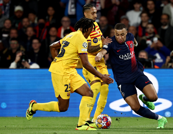 TOPSHOT - Paris Saint-Germain's French forward #07 Kylian Mbappe (R) fights for the ball with Barcelona's Brazilian forward #11 Raphinha (C) and Barcelona's French defender #23 Jules Kounde (L) during the UEFA Champions League quarter final first leg football match between Paris Saint-Germain (PSG) and FC Barcelona at the Parc des Princes stadium in Paris on April 10, 2024. (Photo by Anne-Christine POUJOULAT / AFP) (Photo by ANNE-CHRISTINE POUJOULAT/AFP via Getty Images)