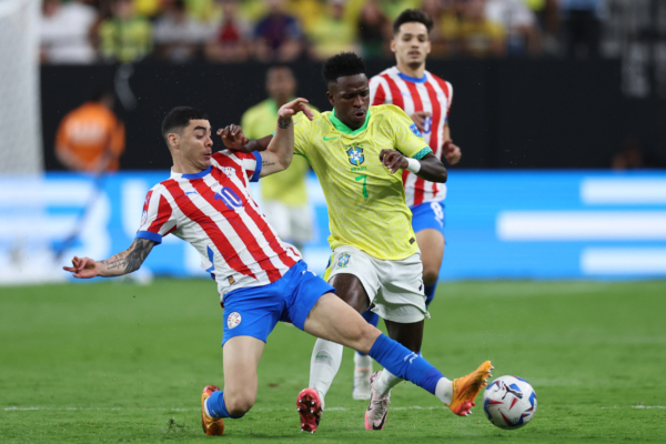 LAS VEGAS, NEVADA - JUNE 28: Miguel Almiron of Paraguay challenges for the ball with Vinicius Junior of Brazil during the CONMEBOL Copa America 2024 Group D match between Paraguay and Brazil at Allegiant Stadium on June 28, 2024 in Las Vegas, Nevada. 