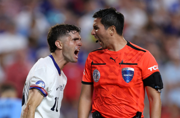 KANSAS CITY, MISSOURI - JULY 01: Christian Pulisic of United States argues with Referee Kevin Ortega during the CONMEBOL Copa America 2024 Group C match between United States and Uruguay at GEHA Field at Arrowhead Stadium on July 01, 2024 in Kansas City, Missouri. 