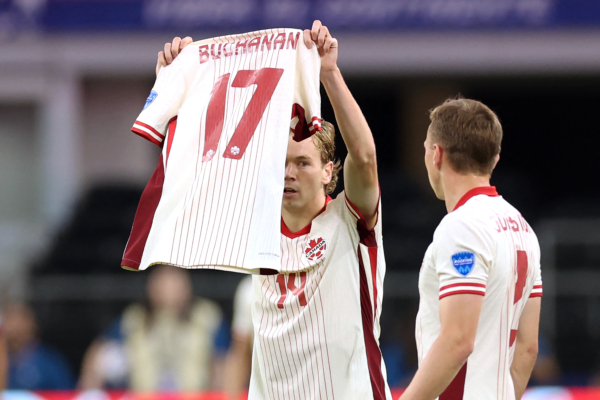 Canada's forward #14 Jacob Shaffelburg celebrates scoring his team's first goal as he holds Canada's forward #17 Tajon Buchanan jersey during the Conmebol 2024 Copa America tournament quarter-final football match between Venezuela and Canada at AT&T Stadium in Arlington, Texas, on July 5, 2024. (Photo by CHARLY TRIBALLEAU / AFP) 