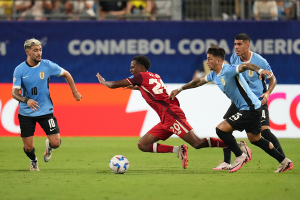 CHARLOTTE, NORTH CAROLINA - JULY 13: Ali Ahmed of Canada and Cristian Olivera of Uruguay battle for the ball during the CONMEBOL Copa America 2024 third place match between Uruguay and Canada at Bank of America Stadium on July 13, 2024 in Charlotte, North Carolina. 