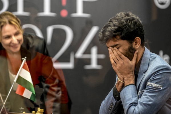 India's grandmaster Gukesh Dommaraju (R) reacts after winning against China's chess grandmaster Ding Liren in game 14 of the 2024 FIDE World Championship in Singapore on December 12, 2024. The 18-year-old became 