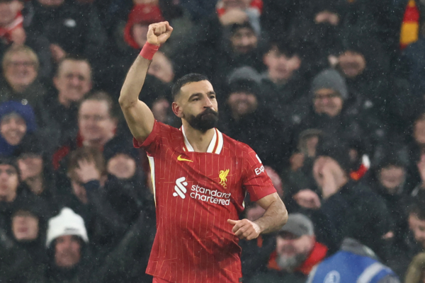 Liverpool's Egyptian striker #11 Mohamed Salah celebrates after scoring their second goal from the penalty spot during the English Premier League football match between Liverpool and Manchester United at Anfield in Liverpool, north west England on January 5, 2025. (Photo by Darren Staples / AFP) / RESTRICTED TO EDITORIAL USE. No use with unauthorized audio, video, data, fixture lists, club/league logos or 'live' services. Online in-match use limited to 120 images. An additional 40 images may be used in extra time. No video emulation. Social media in-match use limited to 120 images. An additional 40 images may be used in extra time. No use in betting publications, games or single club/league/player publications. / 