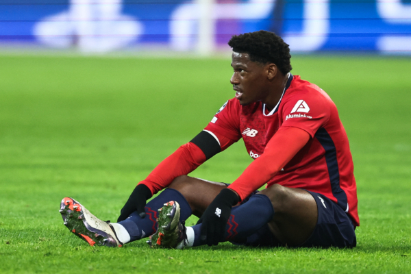 Lille's Canadian forward #09 Jonathan David reacts as he sits on the pitch during the UEFA Champions League, League phase - Matchday 4 football match between Lille OSC (LOSC) and Juventus FC, at Stade Pierre Mauroy, in Villeneuve d'Ascq, northern France, on November 5, 2024. (Photo by Sameer AL-DOUMY / AFP) 