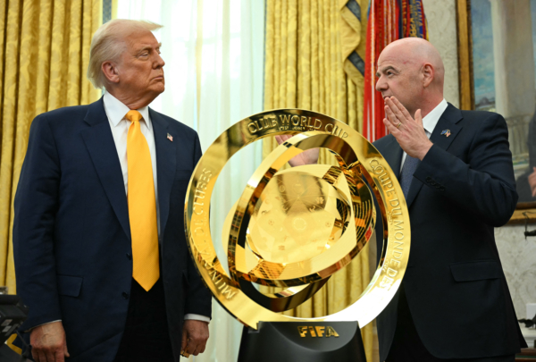 US President Donald Trump and FIFA president (Fédération Internationale de Football Association) Gianni Infantino stand by the new FIFA Club World Cup trophy in the Oval office of the White House, in Washington, DC, on March 7, 2025. (Photo by Jim WATSON / AFP) 