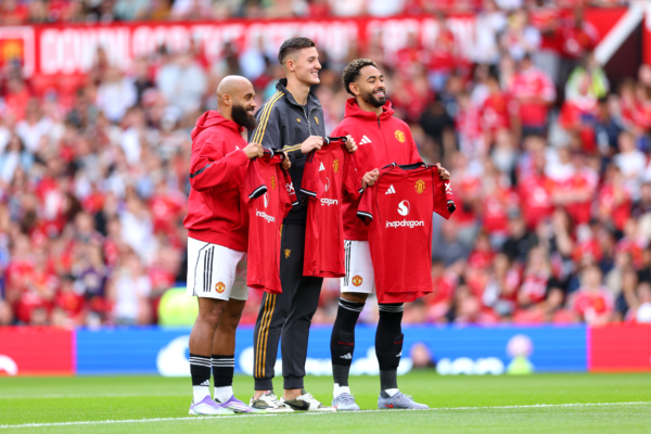 MANCHESTER, ENGLAND - AUGUST 09: New signings Bryan Mbeumo, Benjamin Sesko and Matheus Cunha of Manchester United pose for a photo while holding match shirts prior to the pre-season friendly match between Manchester United and ACF Fiorentina at Old Trafford on August 09, 2025 in Manchester, England. 