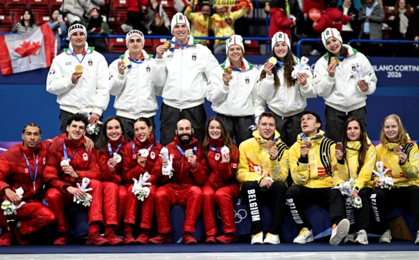 Team Italy, Team Canada and Team Belgium pose for pictures on the podium of the short track speed skating mixed team relay during the Milano Cortina 2026 Winter Olympic Games at Milano Ice Skating Arena in Milan on February 10, 2026.