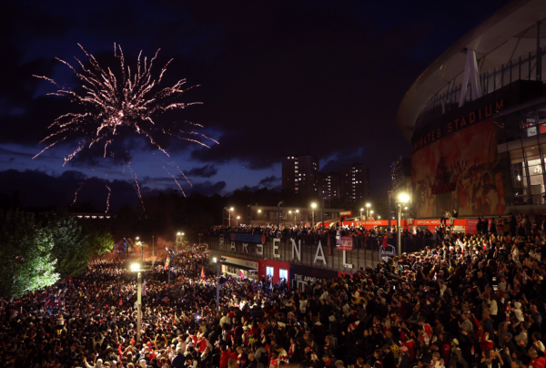 LONDON, ENGLAND - MAY 19: Arsenal fans celebrate winning the Premier League after Manchester City failed to win away to Bournemouth at Emirates Stadium on May 19, 2026 in London, England.