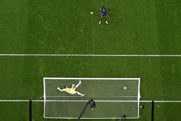 Paris Saint-Germain's French forward #10 Ousmane Dembele scores an equalizing goal from the penalty spot past Arsenal's Spanish goalkeeper #01 David Raya during the UEFA Champions League final football match between Paris Saint-Germain (PSG) and Arsenal FC at the Puskas Arena in Budapest on May 30, 2026.