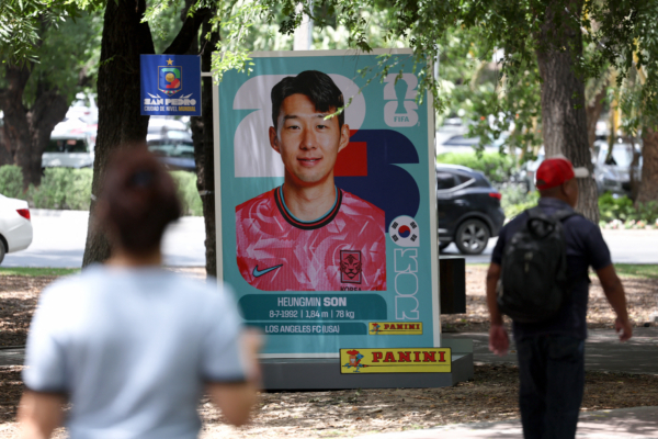 People walk past a big Panini sticker depicting South Korea's forward Son Heung-min in San Pedro Garza Garcia, near Monterrey, Mexico on June 9, 2026, ahead of the 2026 World Cup football tournament. (Photo by Julio Cesar AGUILAR / AFP via Getty Images)