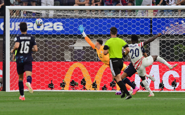 US forward #20 Folarin Balogun (R) scores his team's third goal with teammates during the 2026 World Cup Group D football match between USA and Paraguay at the Los Angeles Stadium in Inglewood on June 12, 2026.