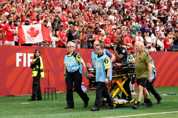 VANCOUVER, BRITISH COLUMBIA - JUNE 18: Ismael Kone #8 of Canada waves to crowd as he is stretched off after being fouled by Assim Madibo #23 of Qatar during the FIFA World Cup 2026 Group B match between Canada and Qatar at BC Place Vancouver on June 18, 2026 in Vancouver, British Columbia.