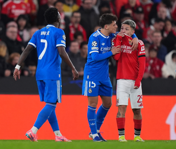 LISBON, PORTUGAL - FEBRUARY 17: Gianluca Prestianni of Benfica speaks towards Vinicius Junior of Real Madrid during the UEFA Champions League 2025/26 League Knockout Play-off First Leg match between SL Benfica and Real Madrid C.F. at Estadio do SL Benfica on February 17, 2026 in Lisbon, Portugal.