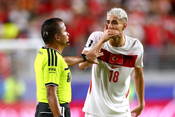 SANTA CLARA, CALIFORNIA - JUNE 19: Mert Muldur #18 of Turkiye flags Miguel Almiron #10 (not pictured) of Paraguay for covering his mouth during the FIFA World Cup 2026 Group D match between Türkiye and Paraguay at San Francisco Bay Area Stadium on June 19, 2026 in Santa Clara, California. Almiron was shown a red card.