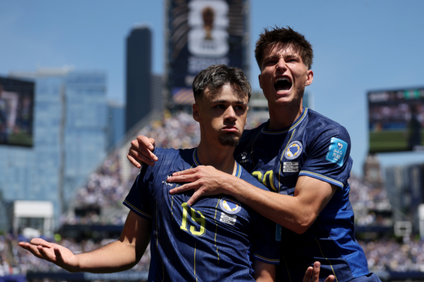 SEATTLE, WASHINGTON - JUNE 24: Kerim Alajbegovic #19 of Bosnia and Herzegovina celebrates with Esmir Bajraktarevic #20 after scoring the team's first goal during the FIFA World Cup 2026 Group B match between Bosnia and Herzegovina and Qatar at Seattle Stadium on June 24, 2026 in Seattle, Washington. 