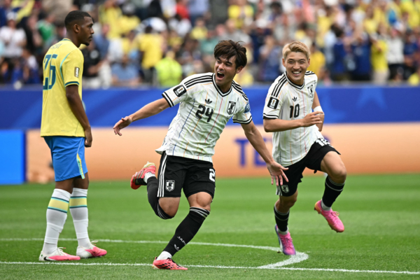 Japan's midfielder #24 Kaishu Sano (C) celebrates after scoring the opening goal during the 2026 World Cup round of 32 football match between Brazil and Japan at the Houston Stadium in Houston on June 29, 2026. 