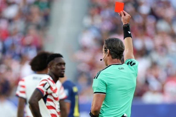 SANTA CLARA, CALIFORNIA - JULY 01: Referee Raphael Claus shows Folarin Balogun #20 of the United States a red card for a foul on Tarik Muharemovic #4 of Bosnia and Herzegovina during the FIFA World Cup 2026 Round of 32 match between USA and Bosnia and Herzegovina at San Francisco Bay Area Stadium on July 01, 2026 in Santa Clara, California.