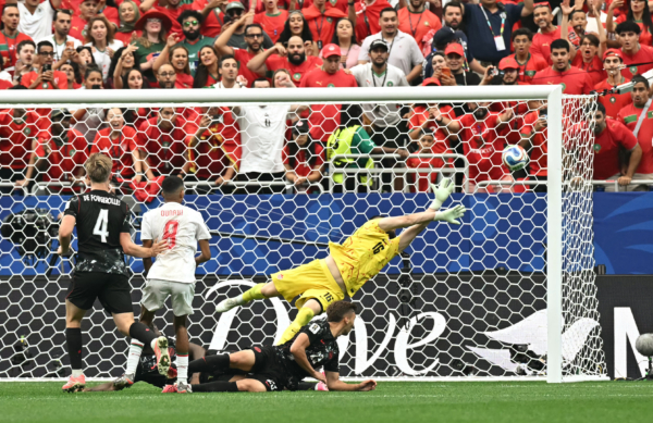 Morocco's midfielder #08 Azzedine Ounahi scores his team's second goal past Canada's goalkeeper #16 Maxime Crepeau during the 2026 World Cup round of 16 football match between Canada and Morocco at the Houston Stadium in Houston on July 4, 2026.