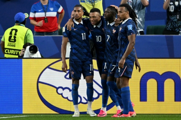 France's forward #07 Ousmane Dembele celebrates scoring his team's third goal with teammates forward #11 Michael Olise, forward #10 Kylian Mbappe, and defender #05 Jules Kounde during the 2026 World Cup Group I football match between France and Iraq at the Philadelphia Stadium in Philadelphia on June 22, 2026.