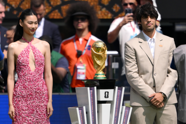 EAST RUTHERFORD, NEW JERSEY - JULY 19: Carlos Alcaraz and Hoyeon present the FIFA World Cup Winner’s Trophy before the FIFA World Cup 2026 Final match between Spain and Argentina at New York New Jersey Stadium on July 19, 2026 in East Rutherford, New Jersey.