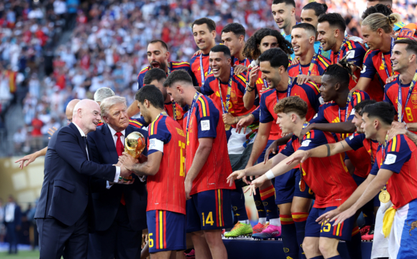EAST RUTHERFORD, NEW JERSEY - JULY 19: Rodri #16 of Spain is presented with the FIFA World Cup Winner’s Trophy by FIFA President Gianni Infantino and U.S. President Donald Trump after the team’s victory following during the FIFA World Cup 2026 Final match between Spain and Argentina at New York New Jersey Stadium on July 19, 2026 in East Rutherford, New Jersey.