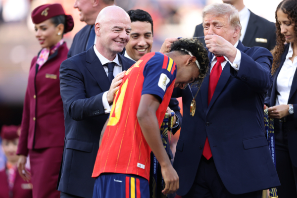 EAST RUTHERFORD, NEW JERSEY - JULY 19: Lamine Yamal #19 of Spain is congratulated by FIFA President Gianni Infantino and U.S. President Donald Trump during the award ceremony after the FIFA World Cup 2026 Final match between Spain and Argentina at New York New Jersey Stadium on July 19, 2026 in East Rutherford, New Jersey.