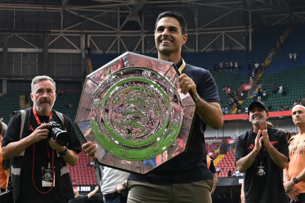 Arsenal's Spanish manager Mikel Arteta celebrates with the trophy on the pitch after their victory in the English FA Community Shield football match between Arsenal and Manchester City at The Principality Stadium, in Cardiff, south Wales on August 16, 2026. Arsenal won the game 3-0.