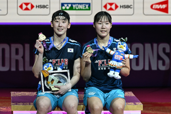 Gold medalists South Korea's Lee So-hee (L) and Baek Ha-na pose on the podium during an awards ceremony after winning against China's Tan Ning and Liu Sheng Shu in their BWF World Championships women's doubles final badminton match at the Indira Gandhi Indoor Stadium in New Delhi on August 23, 2026.